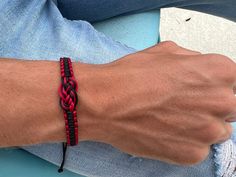 "Black & Dark Red bracelet in the form of a nautical knot (Carrick bend knot) will be a great gift for a sailor.  🪢 Carrick bend also known as the Sailor's breastplate knot is a powerful nautical knot to join two heavy ropes. Thus, this bracelet is a perfect gift for sailors 💕 It's also been called the lover's knot. This bracelet will remind you of your connection with another person. This macrame bracelet is made of a cord. It is adjustable to fit wrists 6.5\" to 8.5\" Please note: Colours ma Adjustable Durable Red Bracelets, Adjustable Durable Wristband For Gift, Durable Braided Bracelet For Gifts, Durable Braided Bracelet For Gift, Casual Red Braided Waxed Cord Bracelets, Casual Red Braided Bracelets As Gift, Casual Red Braided Bracelets For Gift, Red Casual Wristband As Gift, Casual Red Wristband As Gift