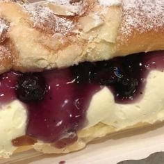 a pastry with blueberries and cream on it