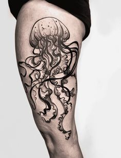 a woman's leg with an octopus tattoo on it, and the legs are covered in black ink