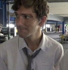 a man wearing a tie standing in an airport