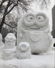 a couple of snow sculptures sitting in the snow