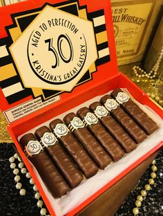 an open box of chocolates with the number 50 on it's front and side