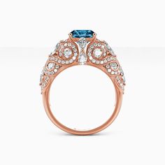 a rose gold ring with blue and white diamonds