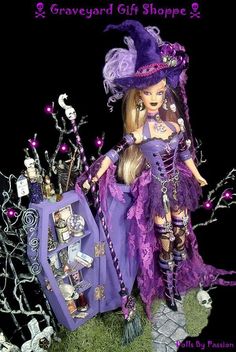 the doll is dressed in purple and holding a bag