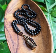 "☾ Created with genuine, Ethically-sourced gemstones:  BLACK ONYX  Courage, Strength, Resiliency, Release of the Old & New Beginnings This artisan mala was lovingly handcrafted with: - Matte Black Onyx 8mm beads, Natural & Ethically-Sourced - Vintage Brass Kuan Yin/Guan Yin Bodhisattva of Compassion Amulet, Thailand - Hematite & Garnet Tassels, Fair Trade Ethiopian Brass & Copper accents This mala features 108 beads, hand-knotted in traditional style between each bead. The beads are each 8mm in Spiritual Onyx Beaded Necklaces With 8mm Beads, Spiritual Onyx Beaded Necklaces, Spiritual Onyx Beaded Necklace, Black Natural Stones Beads For Meditation, Spiritual Black Beaded Necklaces, Spiritual Black Beads Mala For Meditation, Spiritual Black Beads Necklace For Meditation, Spiritual Onyx Beaded Necklace For Healing, Spiritual Black Beaded Necklaces For Meditation