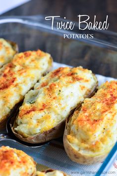 baked potatoes with cheese and seasoning sit on a tray