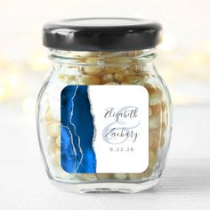 a glass jar filled with white and blue candy