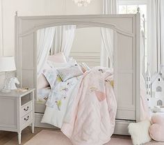 a bedroom with white furniture and pink bedding