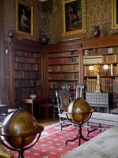 an old library with antique furniture and paintings on the walls