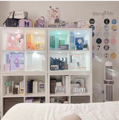 a white bed sitting next to a book shelf filled with books