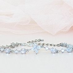 A single strand of diamonds will beautifully complement any wedding dress. Diamonds go with everything, just as lab diamonds go with every color.The CZ marquise will make a perfect finishing touch to your elegant look.DETAILS● Designed and handcrafted by ©JazzyAndGlitzy● This delicate drop and leaf-designed bridal bracelet feature AAA+A grade cubic zirconium.And the finish is with rhodium-plated silver or rose gold.● The bracelet measures 6 inches long + 2 inches extender chain.● Lead, nickel, a Silver Marquise Diamond Cut Bracelet, Classic Sparkling Diamond Bracelet For Wedding, Delicate Cubic Zirconia Wedding Bracelet, Dazzling Diamond Tennis Bracelet For Wedding, Fine Jewelry Marquise Diamond Bracelet For Wedding, Elegant Diamond Cut Crystal Bracelet In Diamond White, Diamond White Crystal Bracelet With Diamond Cut, Diamond Cut Crystal Bracelet In Diamond White, Sparkling Cubic Zirconia Diamond Bracelet For Anniversary