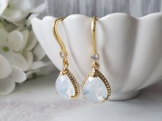 "These beautiful petite dangles are the perfect chic accessory, from that special occasion to an evening out. A beautiful moonstone is subtle for any style. Gold finish over brass. Cubic zirconia studded earwires bring a formal touch. Each glass teardrop measures 13 x 10mm. Total length of earrings are 5/8\" (35mm). Comes ready to gift." Opal Moonstone, Crystal Teardrop Earrings, Moonstone Crystal, Earrings In Gold, Chic Accessories, Teardrop Earrings, Gold Finish, Moonstone, Jewelry Earrings Dangle