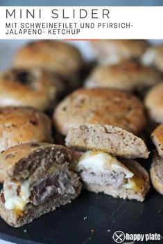 mini sliders with meat and cheese on a black plate