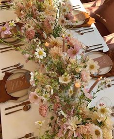 the table is set with white and pink flowers