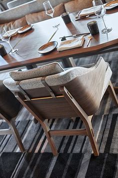 a dining room table with chairs and plates on it