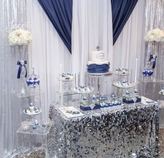 a table topped with lots of cakes and cupcakes