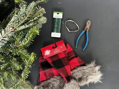 the contents of a christmas tree laid out on a table with scissors, thread and other items