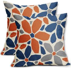 two orange and blue pillows on a white background, each with an abstract flower design