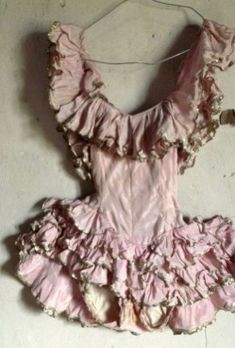 a pink dress hanging on a wall