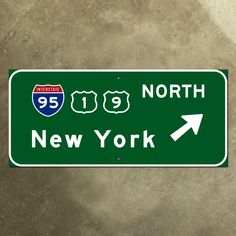 a green street sign that says north new york with an arrow pointing to the right