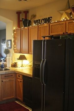 a black refrigerator freezer sitting inside of a kitchen