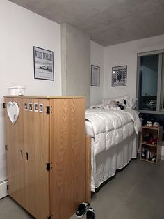 a bedroom with a bed and wooden cabinets