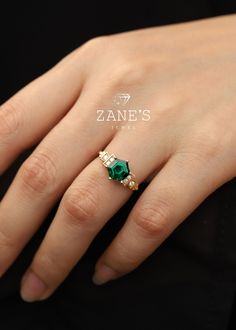 Enhance the magic of your love story with our enchanting Hexagonal Green Emerald Gemstone Tiered Ring. Symbolizing everlasting devotion and unmatched grace, this exquisite ring is a testament to meticulous craftsmanship and boundless creativity. Immerse yourself in the beauty of this extraordinary piece, meticulously designed to captivate hearts and kindle eternal love. Specifications: Main Stone: Gem Type:Natural Diamonds(Green Emerald) Carat Weight: 1.0ct Size: 6.5mm Side Stones: Gem Type: Moissanite/Natural Diamonds Carat Weight: 0.6ct Size: 1.3mm Shape/Color: Hexagonal/Green Metal Options: Weight: Silver: 2.0 grams 10K Gold: 2.5 grams 14K Gold: 2.5 grams 18K Gold: 2.5 grams Platinum: 2.5 grams Ring Length: 13mm Band Width: 1.6mm Band Thickness: 1.2mm Experience the allure of choice wit 14k Gold Octagon Ring For Anniversary, Emerald Cut Birthstone Jewelry For Wedding, Wedding Rings With Asscher Cut For May Birthstone, Asscher Cut Emerald Ring For Wedding, Asscher Cut Wedding Jewelry With Accent Stones, Emerald Princess Cut Wedding Ring As Birthstone, Asscher Cut Emerald Wedding Ring, Fine Jewelry Wedding Ring With Octagon Shape, 14k Gold Asscher Cut Jewelry For Wedding