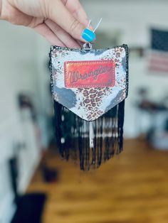 a person holding up a piece of art made from an old window frame with the word morgandale on it