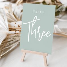 a table sign sitting on top of a wooden easel