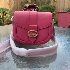 Nwt Coach Pink Saddlebag Product Details Refined Pebble Leather And Smooth Leather Inside Multifunction Pockets Snap Closure, Fabric Lining Outside Open Pocket Detachable Strap With 20 3/4" Drop For Shoulder Or Crossbody Wear 8 1/4" (L) X 6 3/4" (H) X 2 3/4" (W) Style No. C3241 Bundle Your Items And I Will Offer A Good Discount! Thank You For Checking Out My Closet. Designer Crossbody Saddle Bag With Branded Hardware, Coach Flap Bag With Detachable Strap, Pink Flap Bag With Double Handle And Removable Pouch, Coach Top Handle Satchel With Adjustable Strap, Pink Double Handle Flap Bag With Removable Pouch, Top Handle Saddle Bag With Branded Hardware For Travel, Designer Saddle Bag For Shopping, Designer Saddle Bag, Pink Flap Tote Bag With Detachable Handle