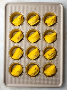 twelve cupcakes in a muffin tin ready to be baked