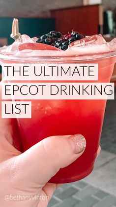 a person holding up a drink with text overlay that reads the ultimate epcot drinking list