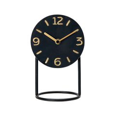 a black and gold clock with numbers on the face is shown against a white background