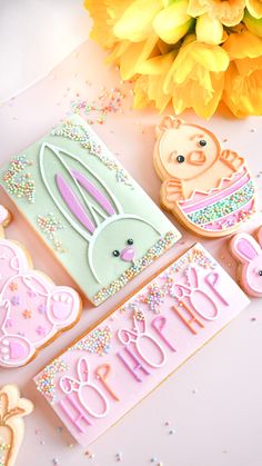 some decorated cookies and flowers on a table