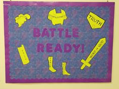 a bulletin board that says battle ready with yellow and purple paper cutouts on it