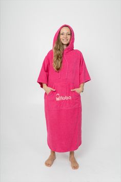 The Pink Hooded Surf Poncho with Sleeves features a kangaroo pocket in front, which includes a separate entrance specifically designed for your mobile phone. Additionally, there are special pockets in the side seams, allowing for easy access to your hands for changing into a wetsuit or swimming trunks without removing the poncho. Surf poncho, beach poncho, beach wears, changing robe, surf wear, surf outfit, hooded poncho, beach towel dress, surf cloclothes, terry cloch Beach Towel Dress, Poncho With Sleeves, Dress With Hood, Terry Cloth Dress, Beach Poncho, Towel Dress, Changing Robe, Hooded Poncho, Cloth Dress