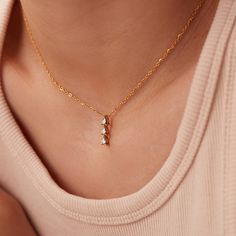 Discover the exquisite beauty of our Dainty Stainless Steel Zircon Pendant Necklace. This stunning piece features a mesmerizing zircon pendant that is meticulously inlaid in high-quality stainless steel. With its 18K PVD gold plating, this necklace exudes a luxurious and elegant appeal. The link chain adds a touch of sophistication, while the adjustable length of 15.5-17.5 inches ensures a perfect fit for every neckline. Elevate your style and make a statement with this captivating necklace, perfect for any occasion or as a thoughtful gift for someone special. Delicate Cubic Zirconia Necklace With Sparkling Stones, Dazzling Delicate Chain Necklace For Wedding, Delicate Necklace With Sparkling Cubic Zirconia, Dazzling Wedding Necklace With Delicate Chain, Dainty Crystal Diamond Necklace With Accents, Delicate Cubic Zirconia Diamond Necklace With Clavicle Chain, Dainty Pendant Necklace With Sparkling Stones, Dainty Necklace With Sparkling Pendant, Gold Diamond Drop Necklace Gift