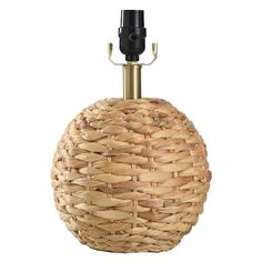 an umbrella holder made out of wicker with a black handle and brass fittings