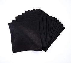 six black napkins sitting on top of each other