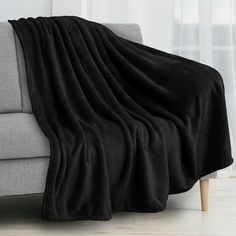 a couch with a black blanket on it