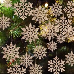 white snowflakes hanging from a christmas tree