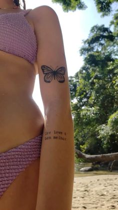 a woman with a butterfly tattoo on her left arm and the words, i love you so much