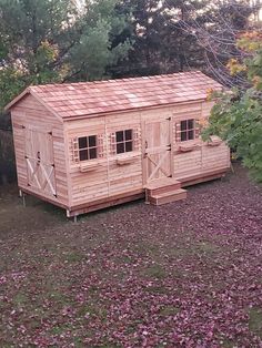 cedar shed with double door entry, single door entry and windows with window boxes Kayak Shed, Motorcycle Storage Shed, Canoe Storage, Cedar Shed, Wooden Storage Sheds, Storage Shed Kits, Motorcycle Storage, Boat Shed, Diy Storage Shed