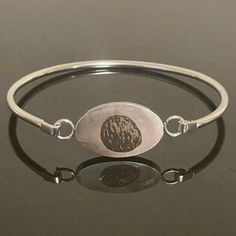 Custom bangle bracelet engraved with your very own embryo!  Stainless steel charm on bangle bracelet. Hypoallergenic, tarnish and rust-proof. Select gift certificate to pre-order this item if you would like to send as a gift but are missing the photo or other details. You will receive a gift certificate via email that can be redeemed by you or another at a later date! Free shipping now or later! Commemorate a transfer or celebrate a new pregnancy with a personalized piece of jewelry showcasing y Etched Metal Bangle As Gift, Silver Engraved Bracelet For Memorials, Engraved Silver Bracelet For Memorial, Silver Engraved Bracelet For Memorial, Memorial Engraved Silver Bracelets, Oval Engraved Bracelets For Gifts, Minimalist Oval Bangle As A Gift, Minimalist Oval Bangle As Gift, Minimalist Oval Bangle Gift