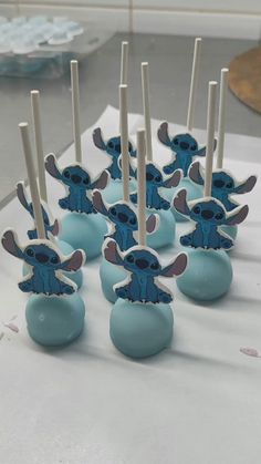 there are many blue cake pops with cartoon characters on them