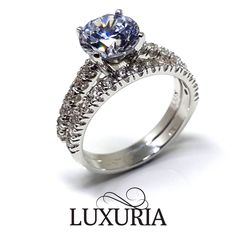 a white gold engagement ring with diamonds on the sides and an oval cut diamond in the center