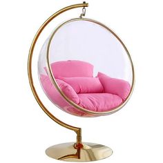 a pink chair in a glass ball on a metal stand with a gold frame and cushion