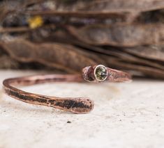 Bangle copper bracelet Rustic jewelry Bangles hammered copper Anniversary gift for wife Raw gemstone bracelets Boho Jewelry Minimalistic Reach for the sun with the Peridot crystal, an effervescent stone that harnesses the life-giving energy that turns night into day. The Vitamin D of your healing crystal collection, the Peridot crystal meaning is connected to the sun, making it your spiritual cheerleader that keeps you on the sunny side of life. The Peridot crystal shines like a light beam of en Hammered Rose Gold Copper Jewelry, Unique Hammered Bracelets As Gift, Unique Hammered Bracelets For Gift, Unique Hammered Bracelets For Gifts, Unique Hammered Bangle As Gift, Rose Gold Copper Bangle As Gift, Spiritual Copper Bangle As Gift, Spiritual Hand Forged Cuff Bracelet Gift, Rose Gold Copper Bracelet As A Gift