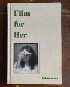 a book with an image of a woman holding a camera in front of her face