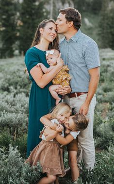 a man and woman holding two small children